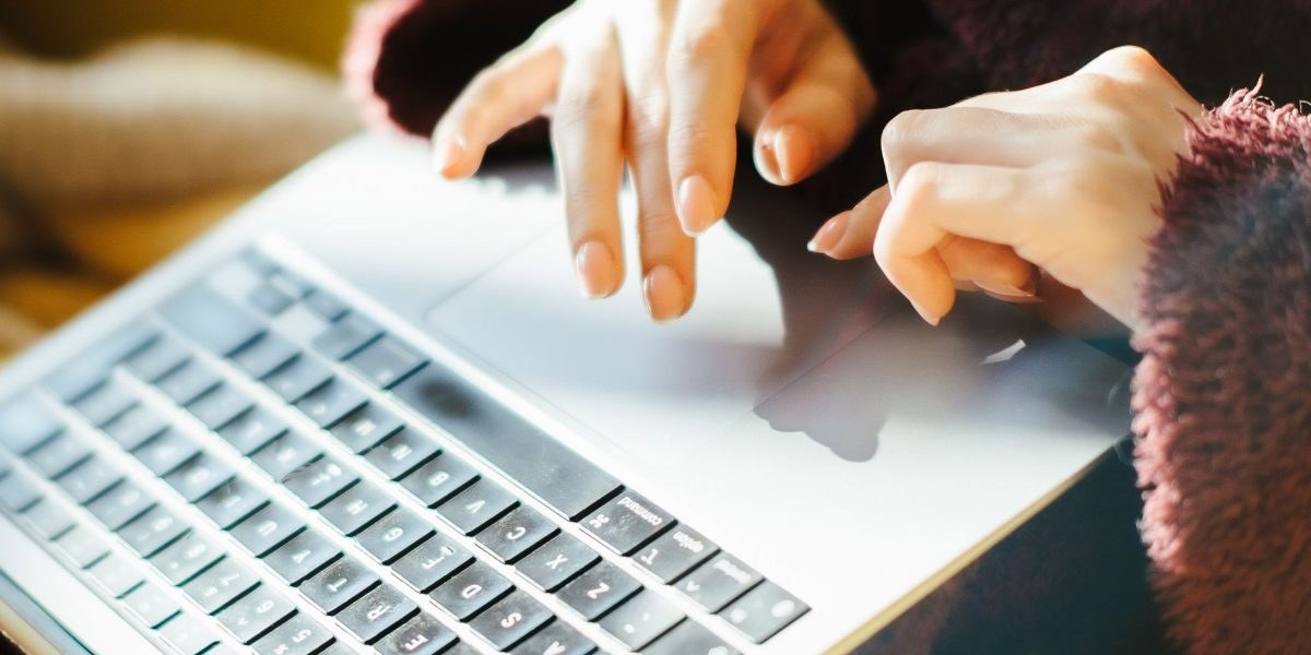 Person composing a supportive message on their laptop
