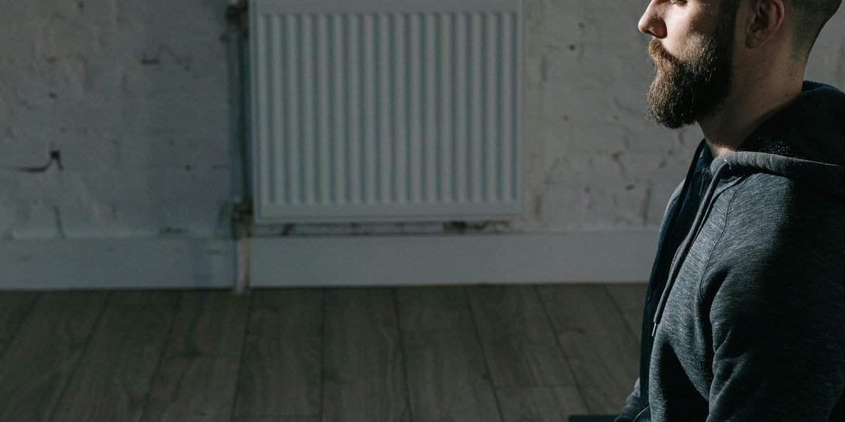 An individual engaging in a calm, focused activity, demonstrating a mindfulness or breathing exercise for anxiety relief.