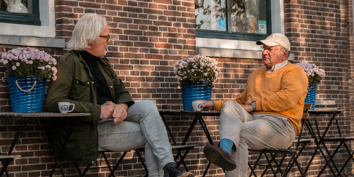 Individuals engaging in a light, friendly conversation, representing the act of building social connections.