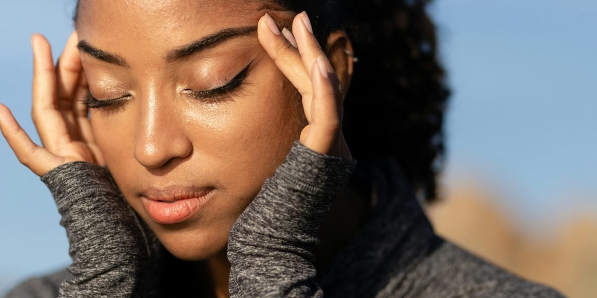 A person in a contemplative pose, reflecting on their feelings and mental state, symbolizing self-awareness.