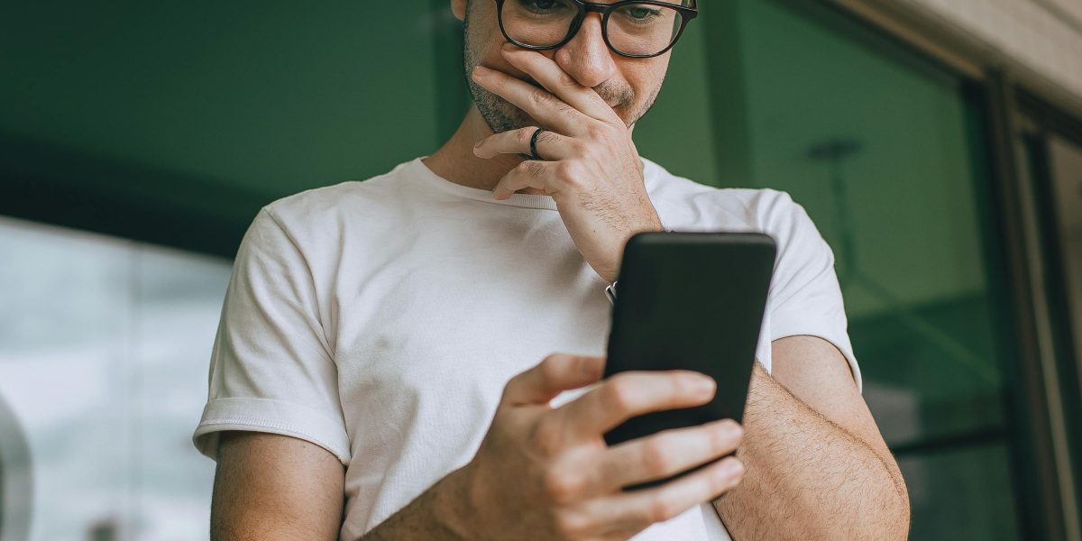 A person using their phone for a therapy aid or reflection, in a calm, focused setting.