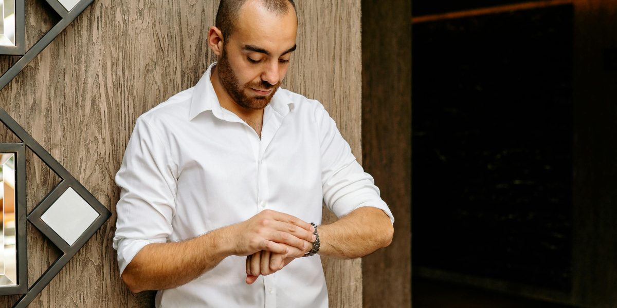 A person looking at their smartwatch with a calm expression, possibly in response to biofeedback.