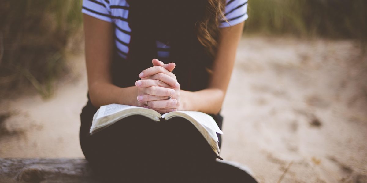 A person meditating in a peaceful outdoor setting, practicing mindfulness.