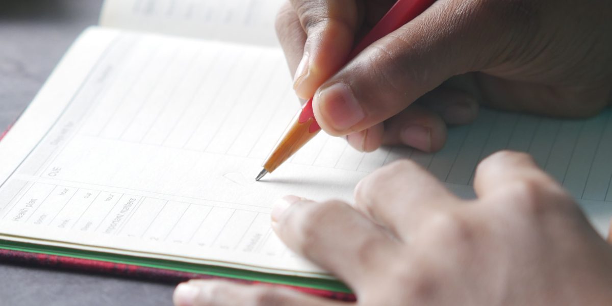 A person focused on planning their daily activities, demonstrating behavioral activation.
