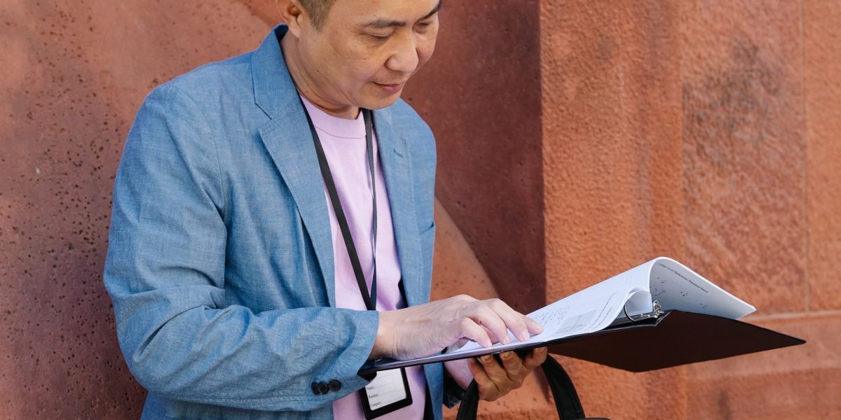 A person reviews notes, confidently preparing for an important meeting or consultation.