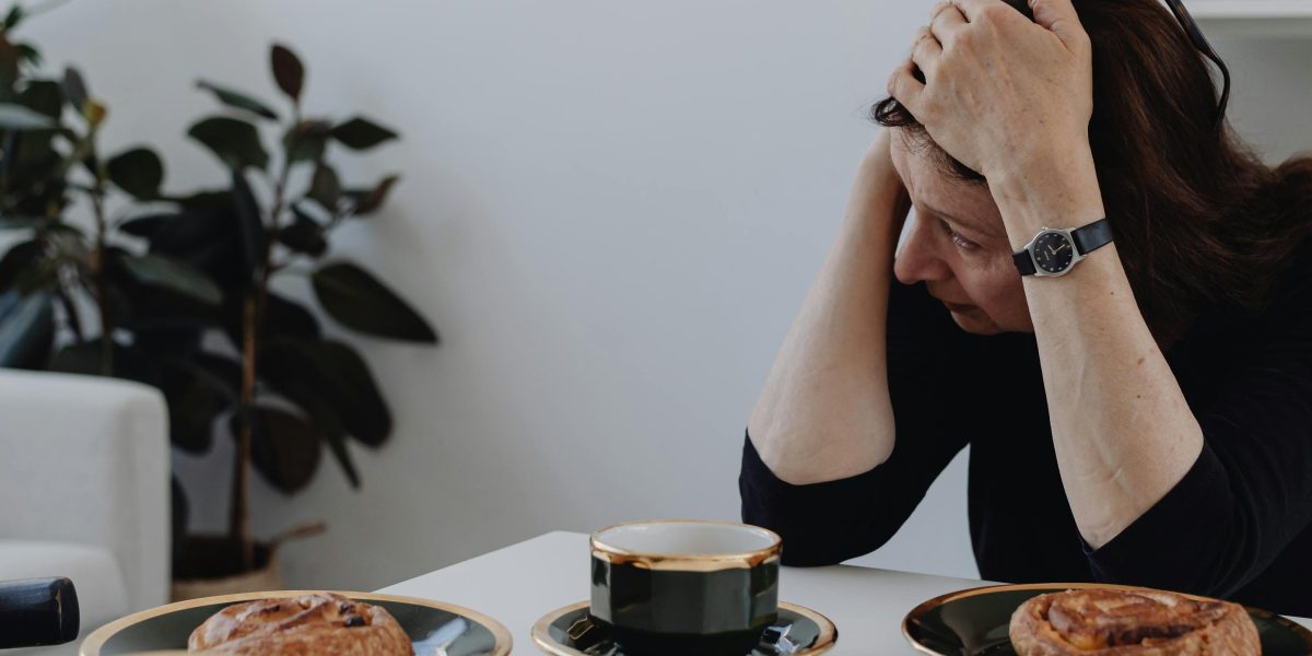 A person appears deep in thought or feeling overwhelmed, symbolizing the internal struggle of living with IED.