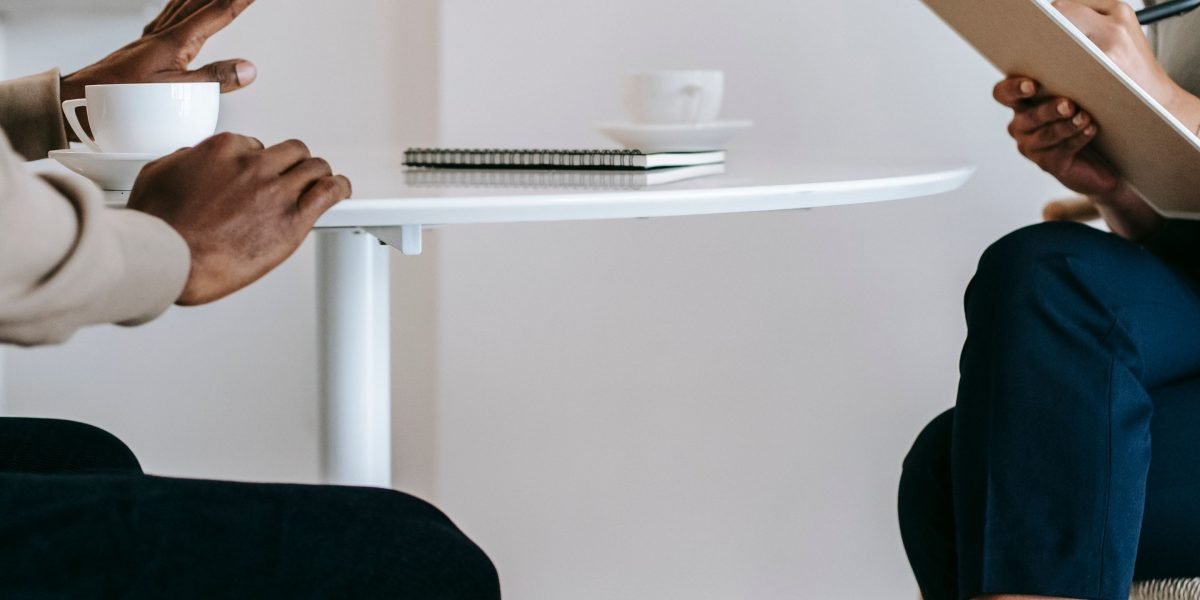 A therapist and client engage in a supportive conversation, representing the process of learning new coping mechanisms.