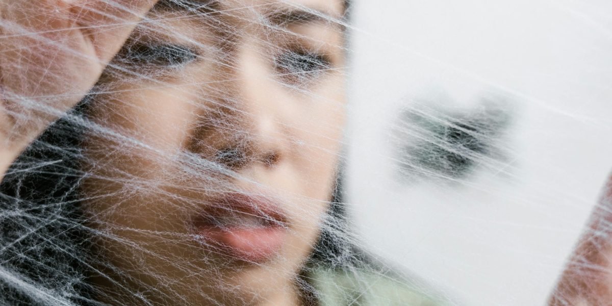 A person looking thoughtful and distressed, representing the challenges of living with PTSD.
