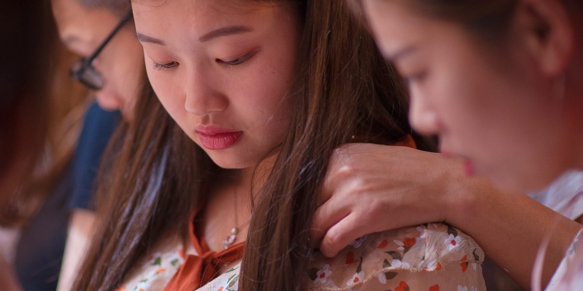 A person feeling a moment of hesitation or shyness in a social environment.