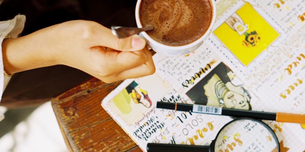 A person reviewing their notes or journal, reflecting on their journey and achievements.