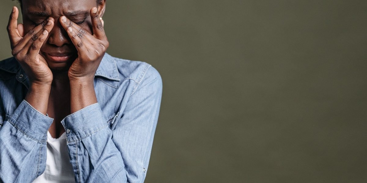 A person reflects, symbolizing the heavy burden of mood and anxiety disorders.