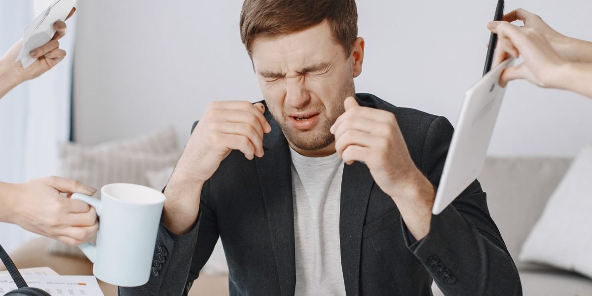 A person feeling overwhelmed in a busy environment, reflecting the sensory overload often experienced by HSPs.