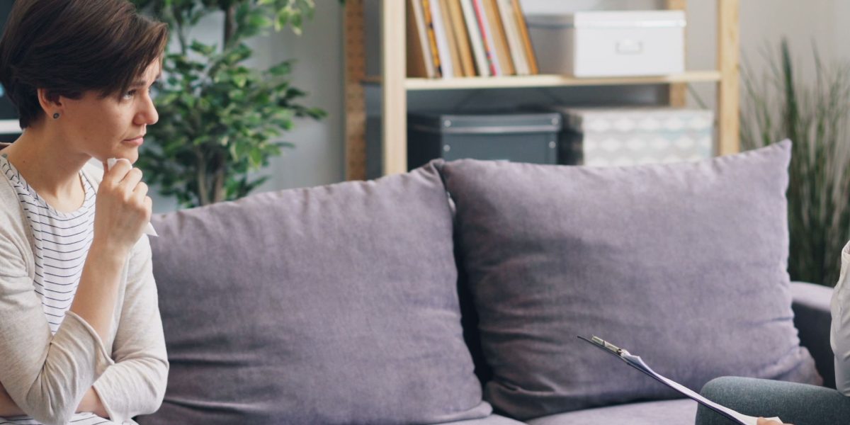 A therapist and client in a calm setting, conveying a sense of understanding and validation.