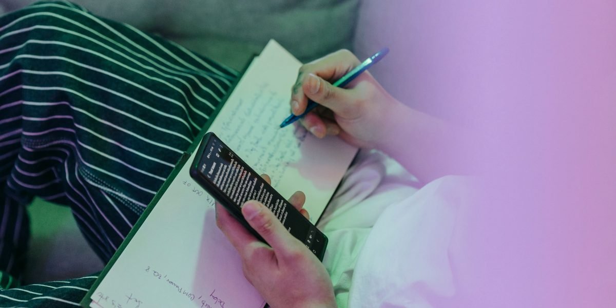 A person thoughtfully writing notes, preparing for an important discussion or therapy session.