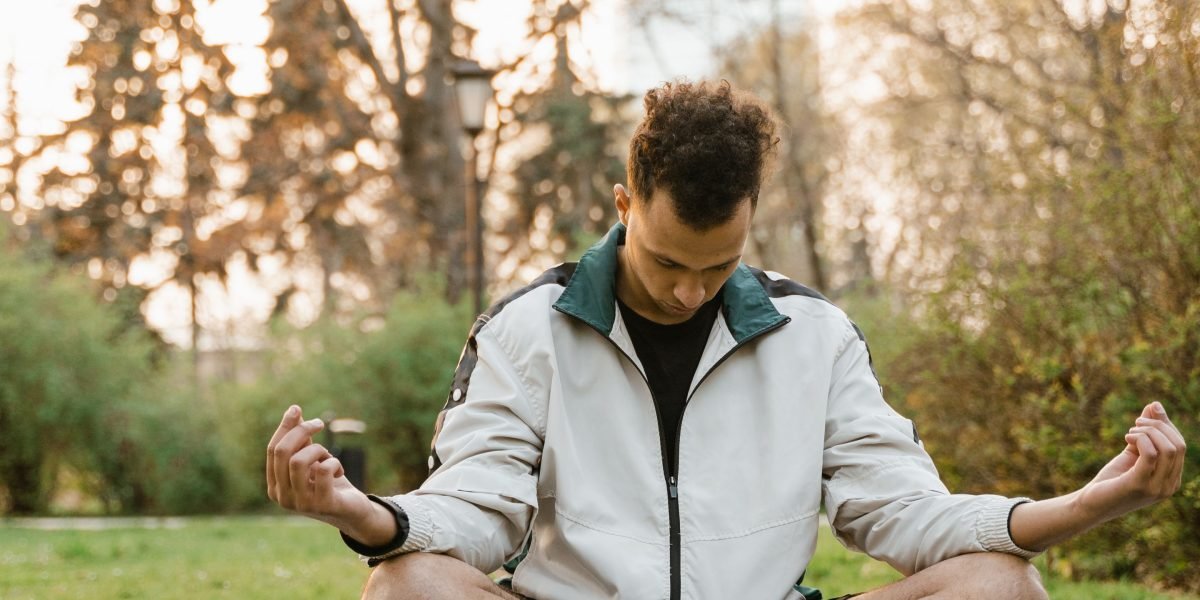 A person practicing mindfulness in a calm outdoor setting, integrating therapy principles into daily life.