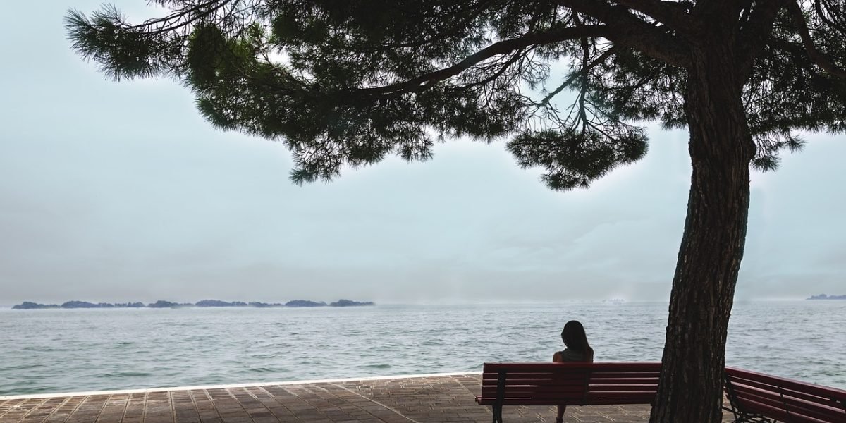 A scene depicting a person engaged in thoughtful reflection, symbolizing the internal process of self-discovery and the potential for change through self-acceptance.