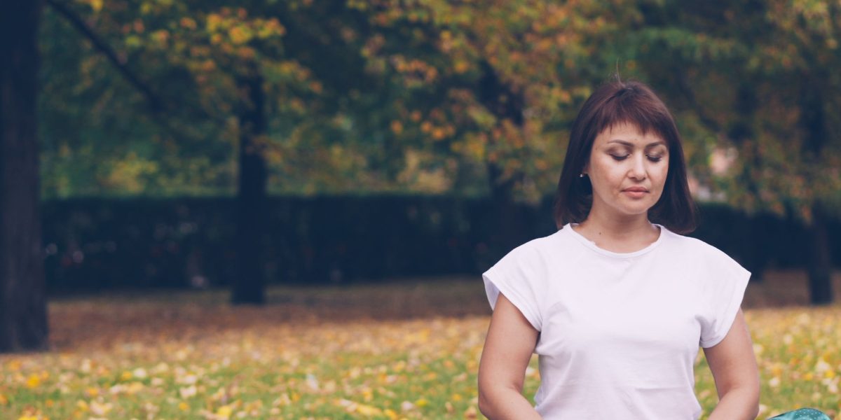 A tranquil scene of a person engaged in mindfulness or meditation, reflecting the integration of body awareness and present-moment focus in holistic therapy.