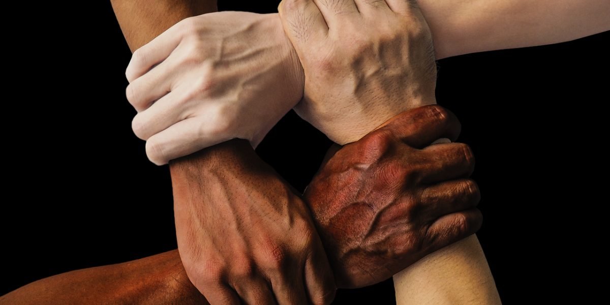 A diverse group of individuals experiencing a strong sense of community and mutual support.