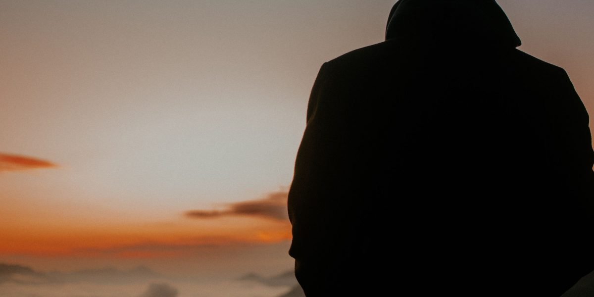 A person contemplating a significant decision, representing the initial courage to seek help for mental health.