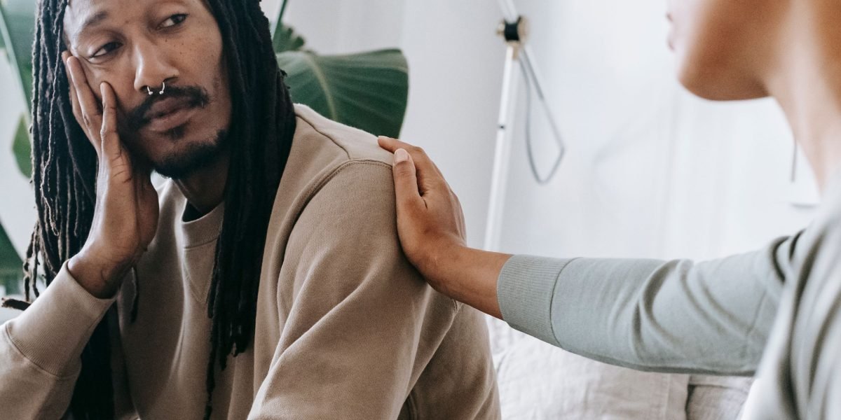 Two individuals engaged in a calm and empathetic conversation, representing the establishment of trust in a therapeutic setting.