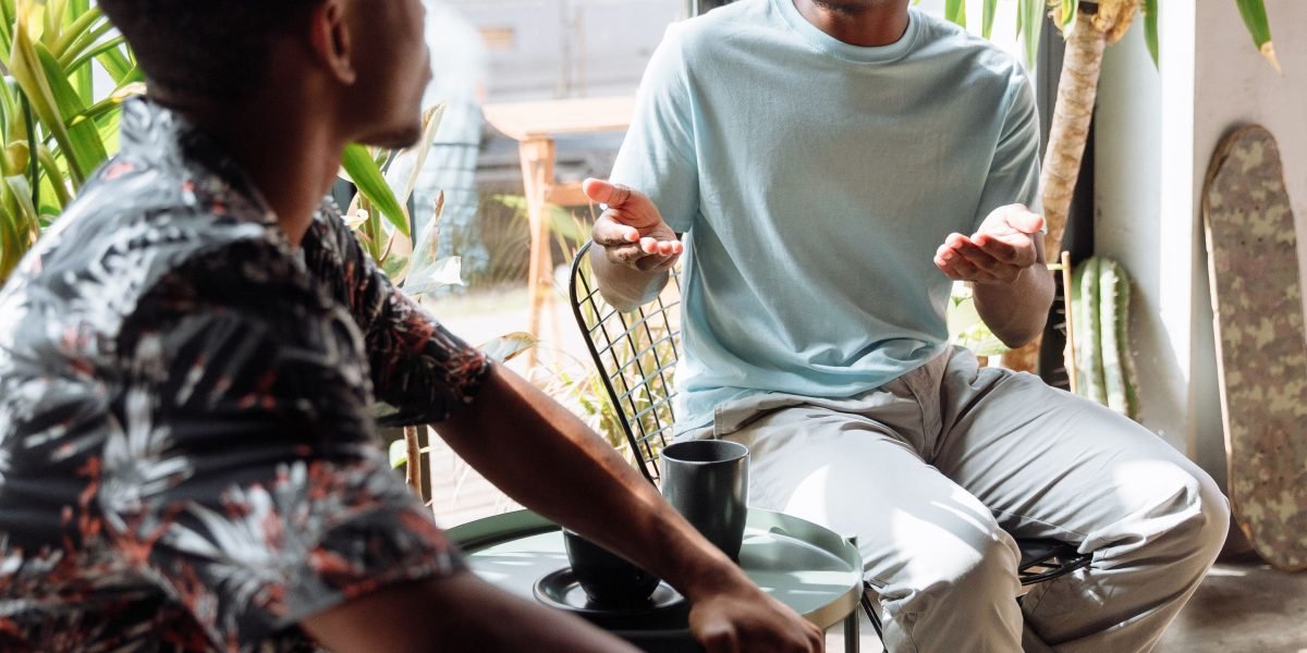 A person engages in a supportive conversation, symbolizing the step towards seeking professional mental health guidance.