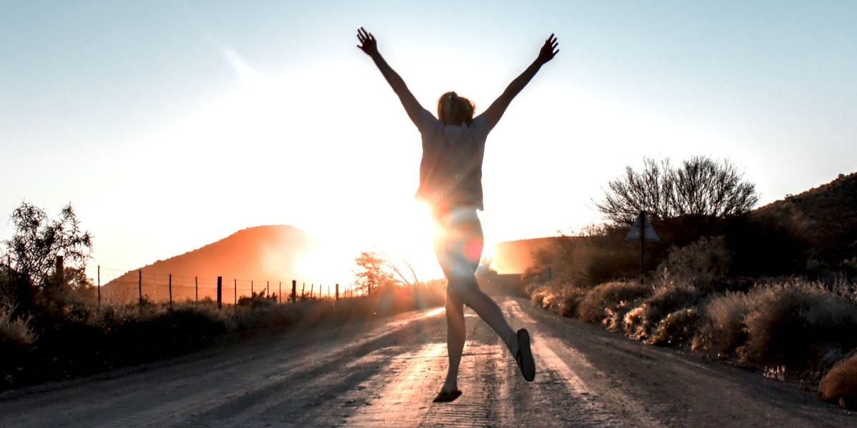 A person looks empowered and hopeful, illustrating the positive outcome of navigating and overcoming barriers to care.
