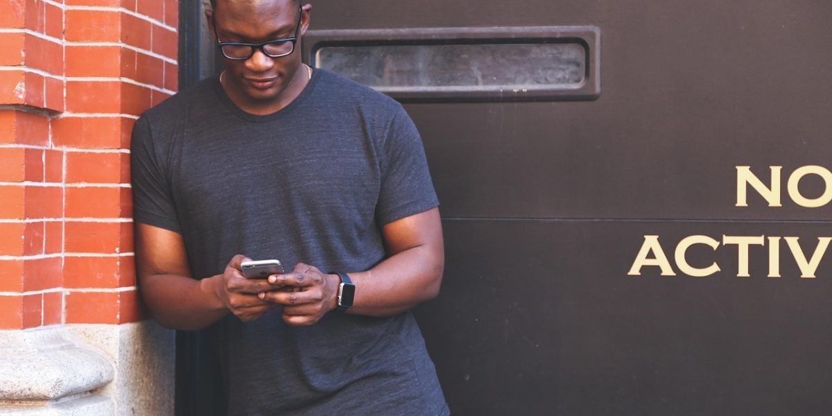 A person using a smartphone, potentially engaging with a digital tool designed for self-care or habit building.