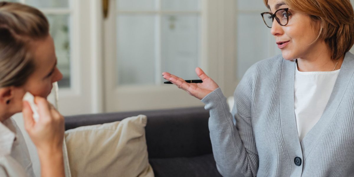 A person having an open and reassuring conversation with a therapist in a professional setting.