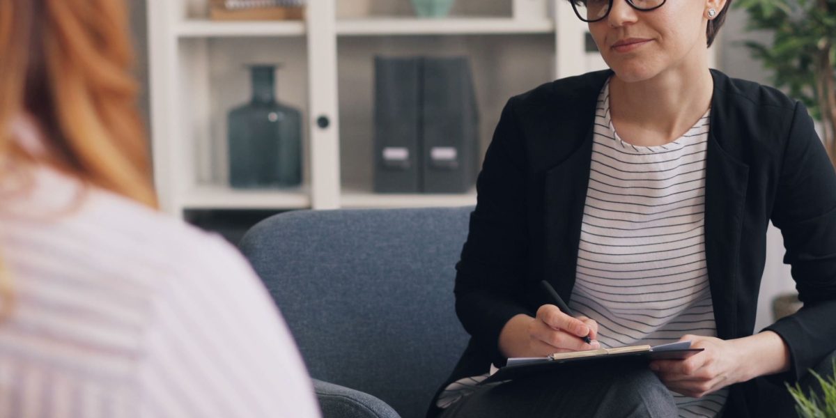 An individual thoughtfully considering their options for mental health support, ensuring the therapist's skills match their unique needs.